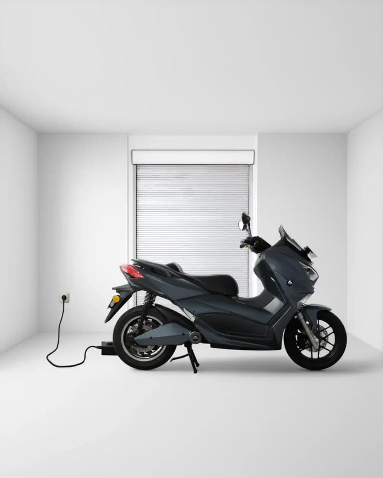 EdPower plugged into a home charger in a clean, modern garage
